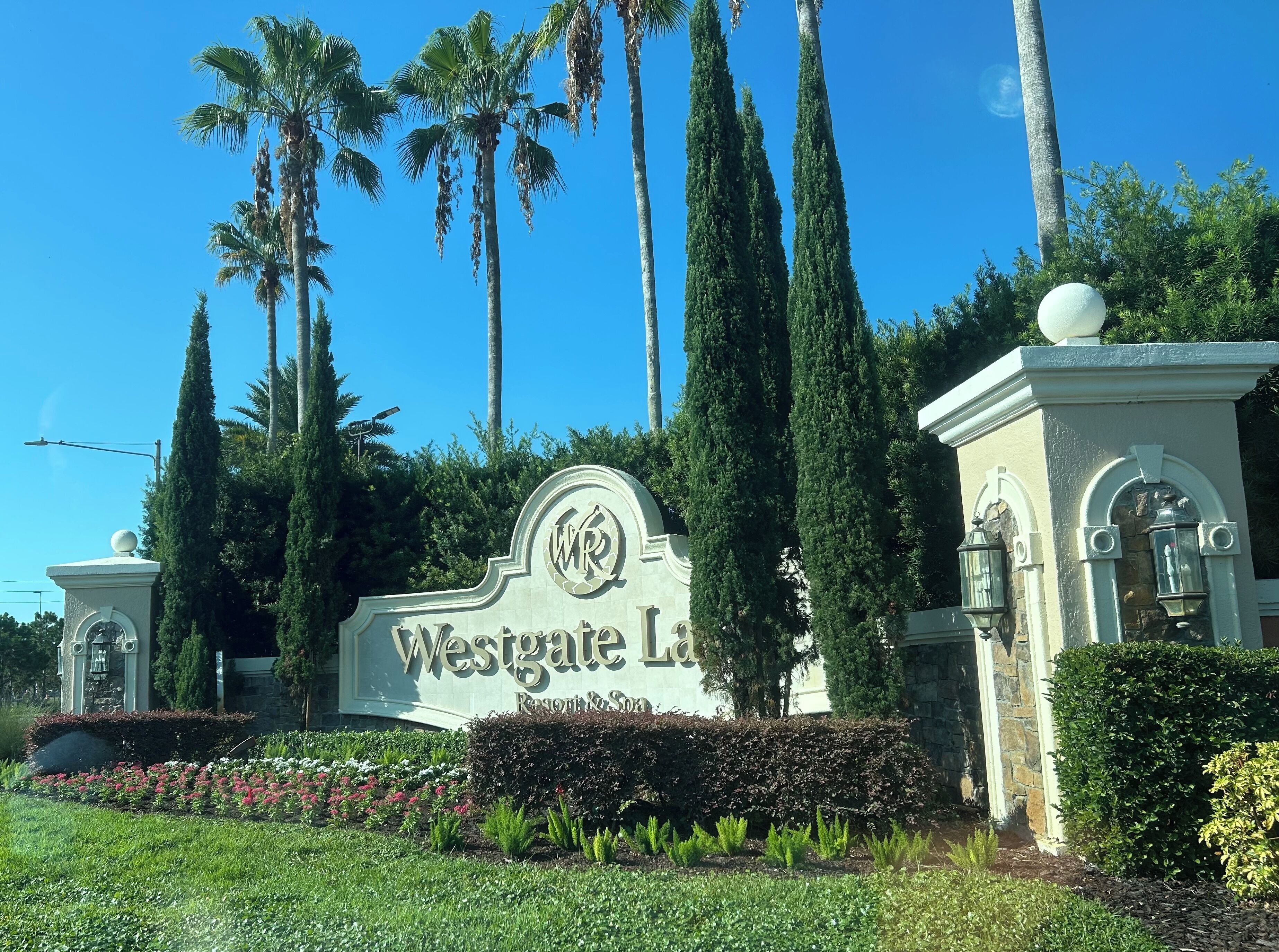 A sign for Westgate Las Vegas Resort & Spa surrounded by palm trees and well-maintained landscaping.