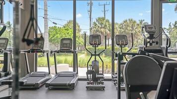 A gym with treadmills, elliptical machines, and weight equipment.