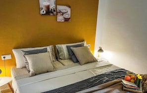 A bed with a white and gray bedspread, two pillows, and a bedside table with a lamp. - Lovely home in Rojales with sauna (Rojales)