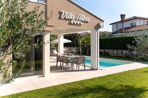 A villa with a covered outdoor seating area, a swimming pool, and a well-maintained lawn. - Villa Alina (Istria - Poreč) (Poreč)