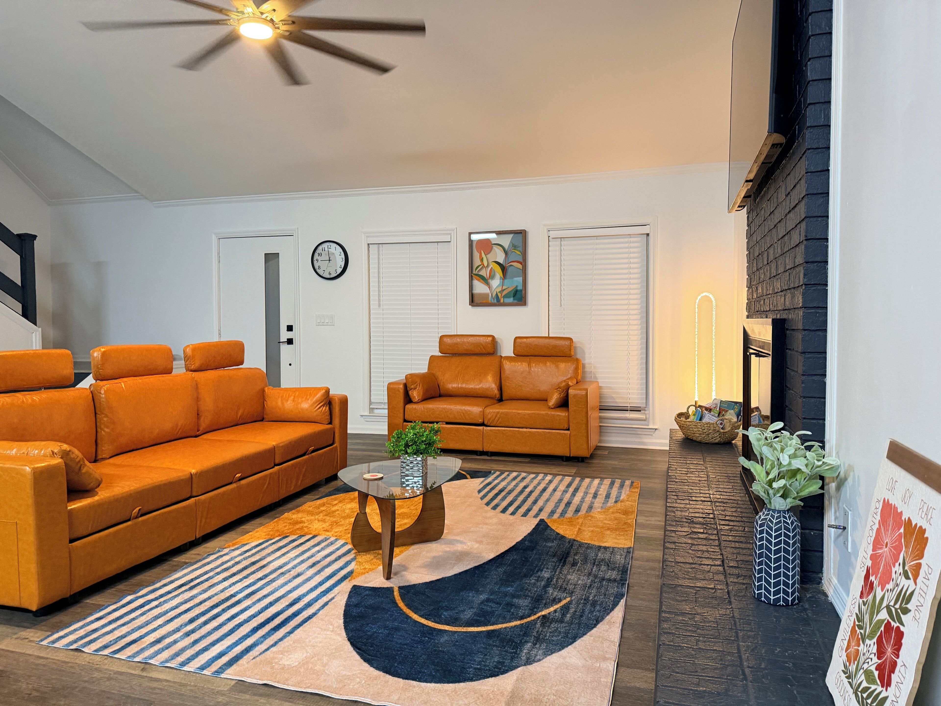 A living room with two sofas, a coffee table, and a fireplace.