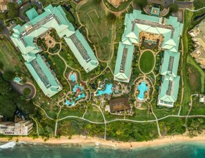 An aerial view of a resort with multiple buildings, swimming pools, and a beach. - KLVR Presents Honua Kai Hokulani 1034 Penthouse (Lahaina)