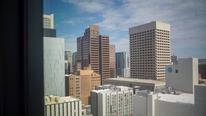 A cityscape with various high-rise buildings, including a prominent square building with a distinctive top and a tall rectangular building with a grid pattern. - 2-bedroom apartment in soothing Phoenix with AC and fitness room (Phoenix)