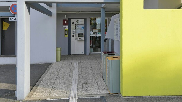 The entrance to a B&B hotel with a sign reading 'ACCUEIL' and a visible entrance door.
