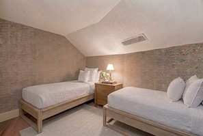 A bedroom with two single beds, a nightstand with a lamp, and a patterned wall. - Ritz Carlton Bachelor Gulch 2-Bed+Loft Residence (Edwards)