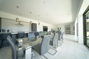A modern kitchen with a dining area. - Reunion Haven Villa-1209 (Kissimmee)