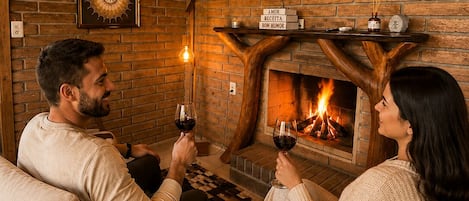 A cozy room with a fireplace, a television mounted on the wall, and a checkered floor.