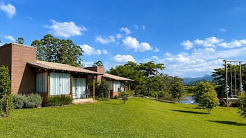 A two-story house with a well-maintained lawn and a clear blue sky.