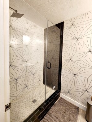 A shower with a glass door and a geometric tile pattern on the walls. - 1-bedroom/B Resort On Free Shuttle to Ski IN/Out Historic Main Pool Hottub Trail (Park City)