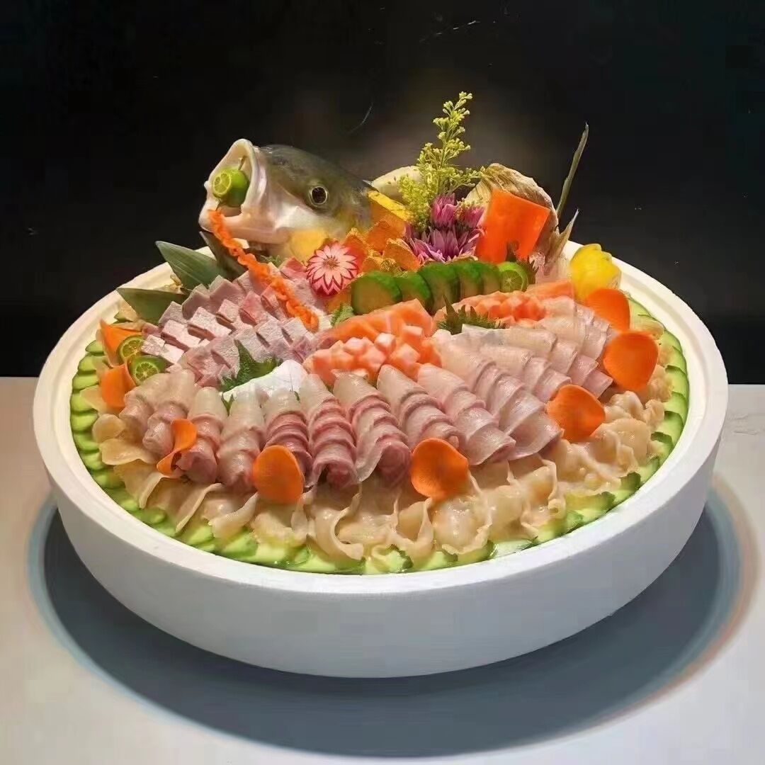 A round table with a white plate containing various food items.