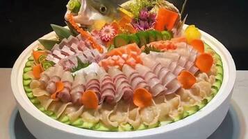 A round table with a white plate containing various food items.
