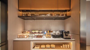 A modern kitchen with a built-in coffee station, a toaster, and various food items.