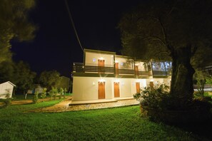 A two-story building with a balcony, a stone pathway, and a well-maintained lawn. - Eleonas Bohotel & Annex Apartments (Corfu)