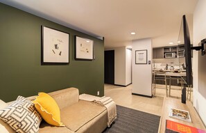 A modern living room with a sofa, a yellow pillow, and framed artwork on the wall. - Casa Sócrates By Kukun (Mexico City)