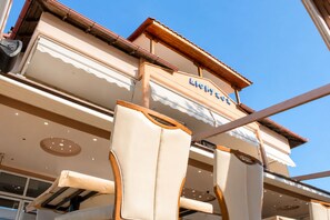 A hotel with a prominent sign, large windows, and a modern architectural design. - Dionysos Hotel (Kassandra)