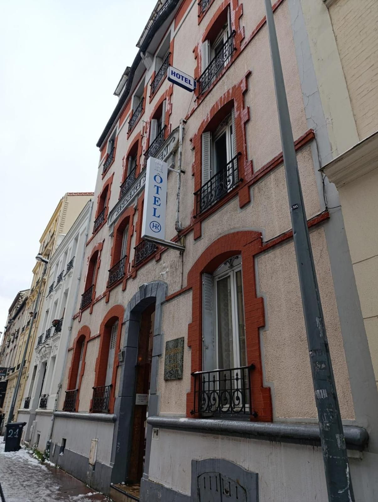 A hotel building with a sign indicating it is a hotel.