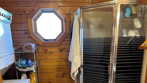 Een kleine badkamer met douche, toilet en een wastafel.