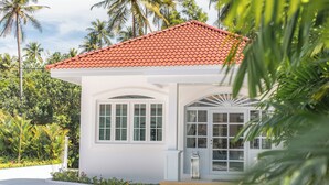 A white building with a red-tiled roof, arched windows, and a white door with glass panels. - Villa Carpe Diem by Elite Havens (Natai)