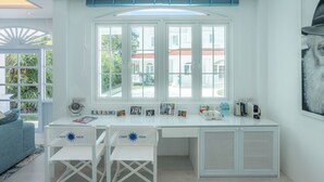 A bright room with a large window, a white desk, two white chairs, and a radiator. - Villa Carpe Diem by Elite Havens (Natai)