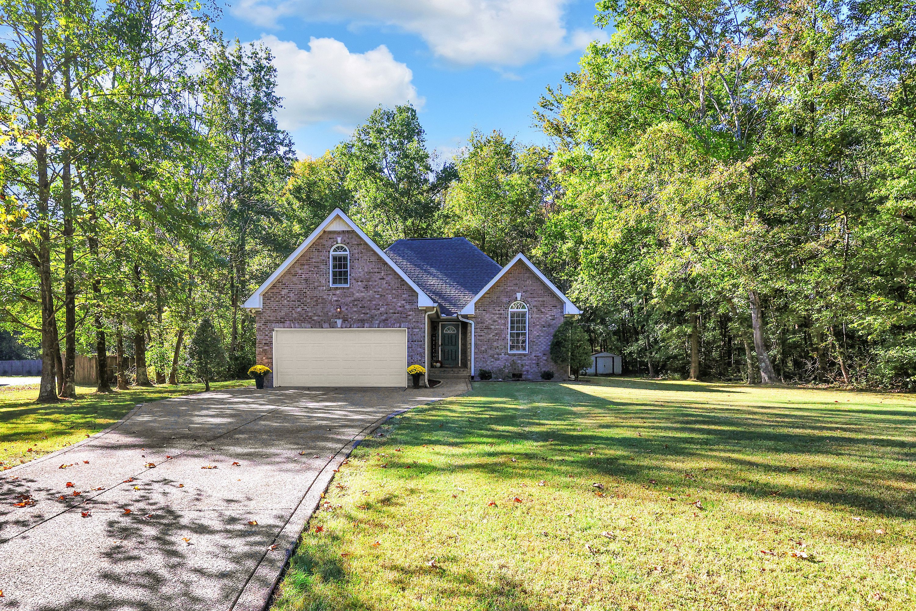 Tucked at the end of a quiet cul-de-sac, a private brick retreat in mature woods