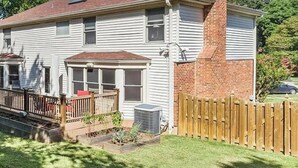 A two-story house with a brick chimney, a satellite dish, and a fenced backyard. - Beautiful Lakeside Home 7 Minutes from Bellerive CC (Chesterfield)