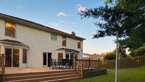 A two-story house with a patio, a deck, and a fenced backyard. - Beautiful Lakeside Home 7 Minutes from Bellerive CC (Chesterfield)