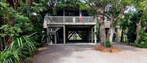 A two-story building with a balcony, a flag, and a sign that reads 'EAST THE SEA'.