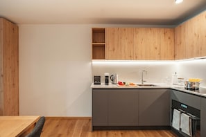 Coffee/tea maker, fridge, oven, stovetop - Modern Alpine Stay in San Bernardino | Ski, Hiking & Nature - Castanea 309, San Bernardino, Switzerland (San Bernardino)