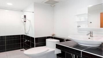Un baño moderno con inodoro, bidé y lavabo.