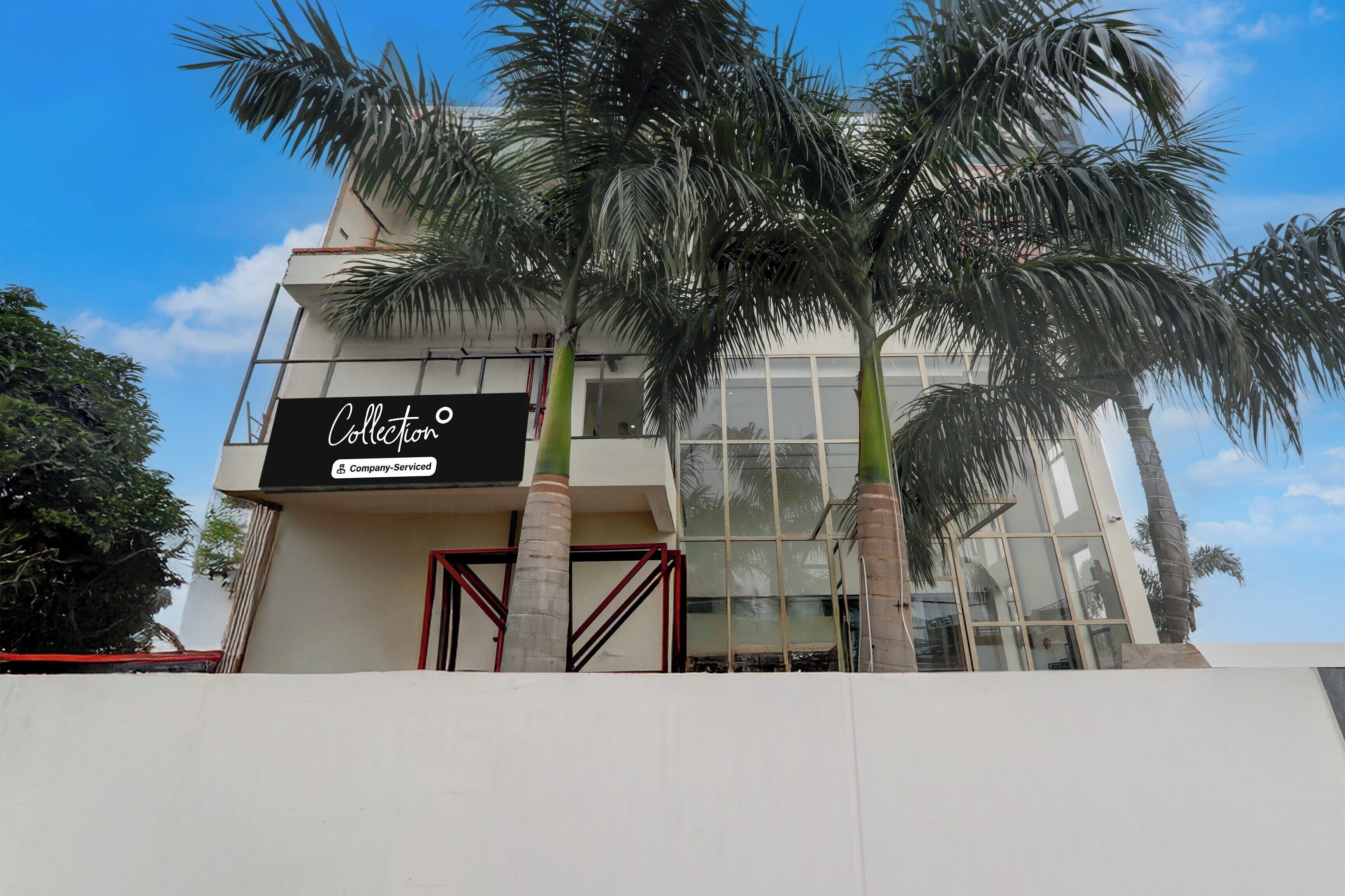 A modern building with a sign that reads 'Collection Company-Serviced.'