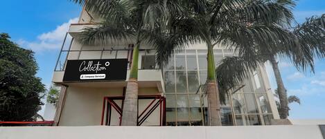 A modern building with a sign that reads 'Collection Company-Serviced.'