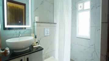 A bathroom with a sink, toilet, and shower curtain.