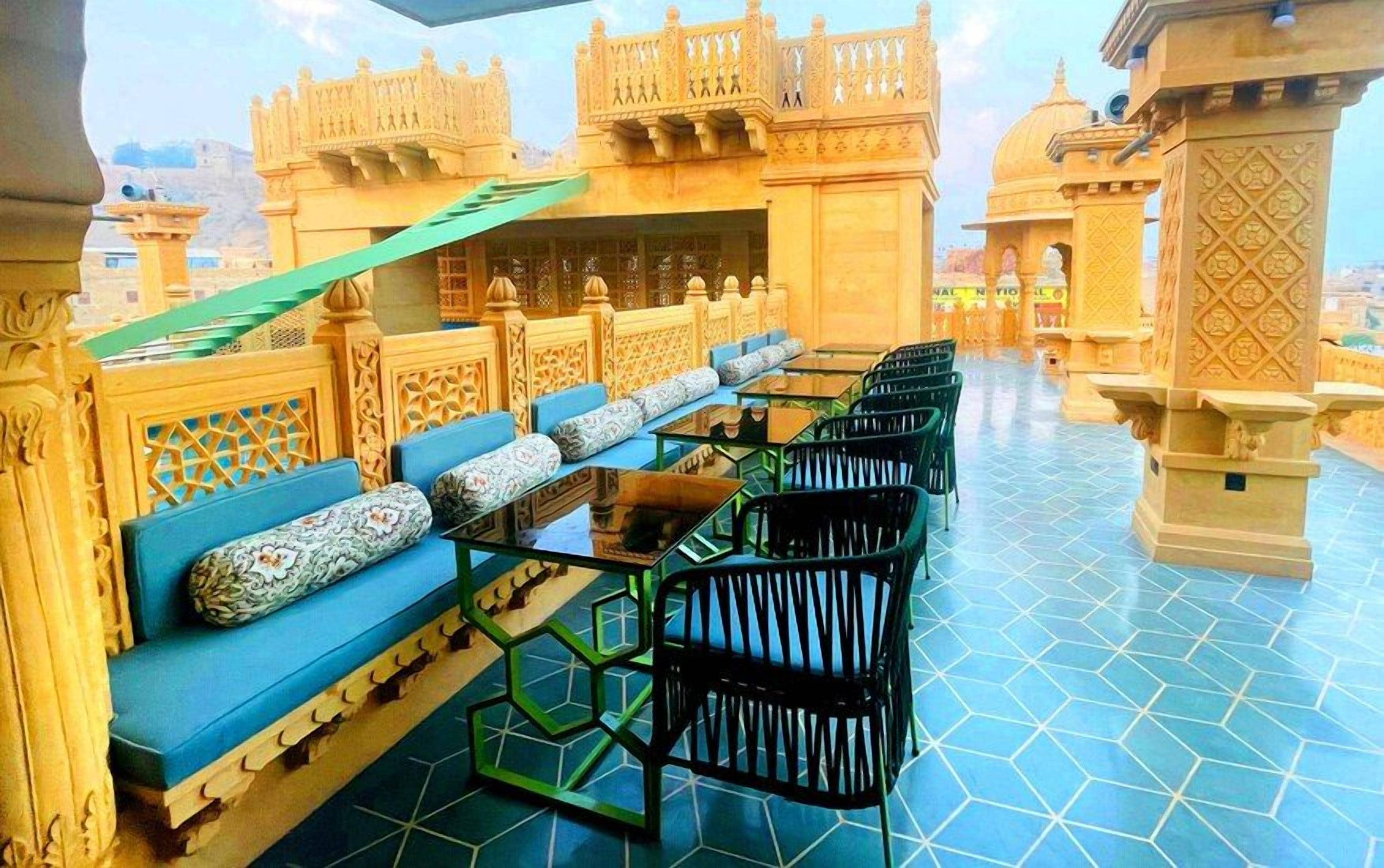 A terrace with a seating area, including sofas and chairs, and a table.