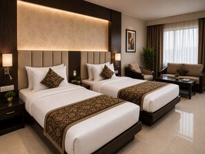 A hotel room with two beds, a sofa, a chair, a nightstand, a lamp, and a window with curtains. - The Regaal - 5 mins from Railway Station (Jalgaon)