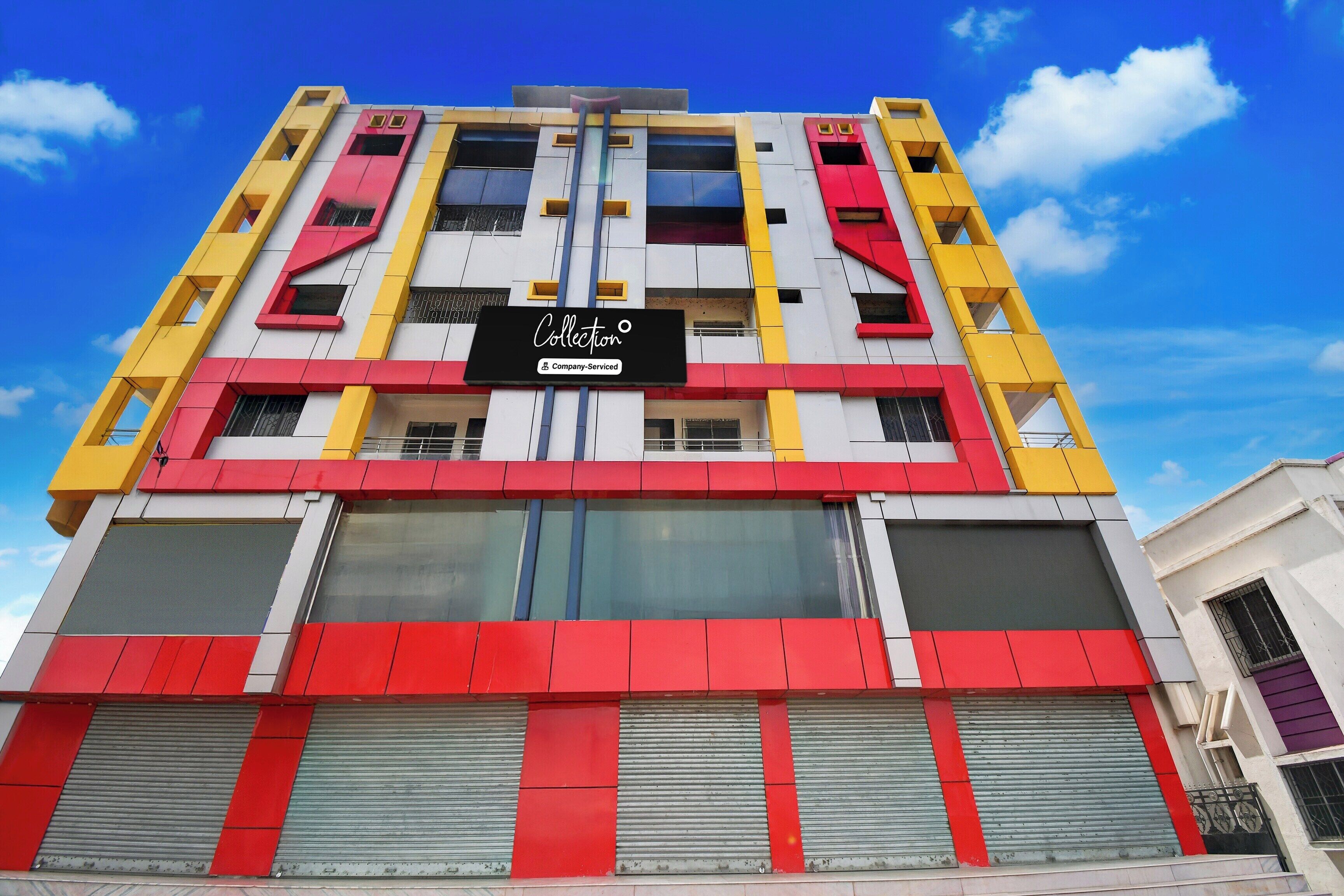 A multi-story building with a prominent 'Collection' sign, large windows, and a modern architectural design.