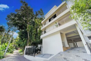 A modern two-story building with a sign indicating it is a collection & company-serviced property. - Collection O Valiyavila Junction (Thiruvananthapuram)