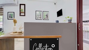 A reception desk with a sign reading 'Collection'.
