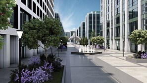 A modern urban street with buildings, trees, and a clear sky. - AC Hotels by Marriott Airport City Belgrade (Belgrade)