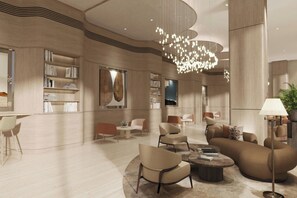 A modern interior with a central seating area, bookshelves, and a unique ceiling light fixture. - AC Hotels by Marriott Airport City Belgrade (Belgrade)
