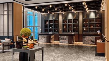 A modern interior with a marble floor, a reception desk, and a wall of shelves with various items.