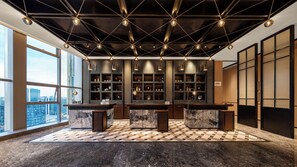A modern interior with a checkered floor, marble countertops, and a city view.