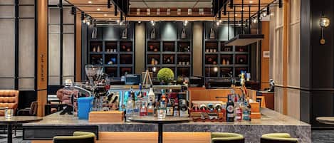 A bar area with seating, shelves with bottles, and a decorative ceiling.