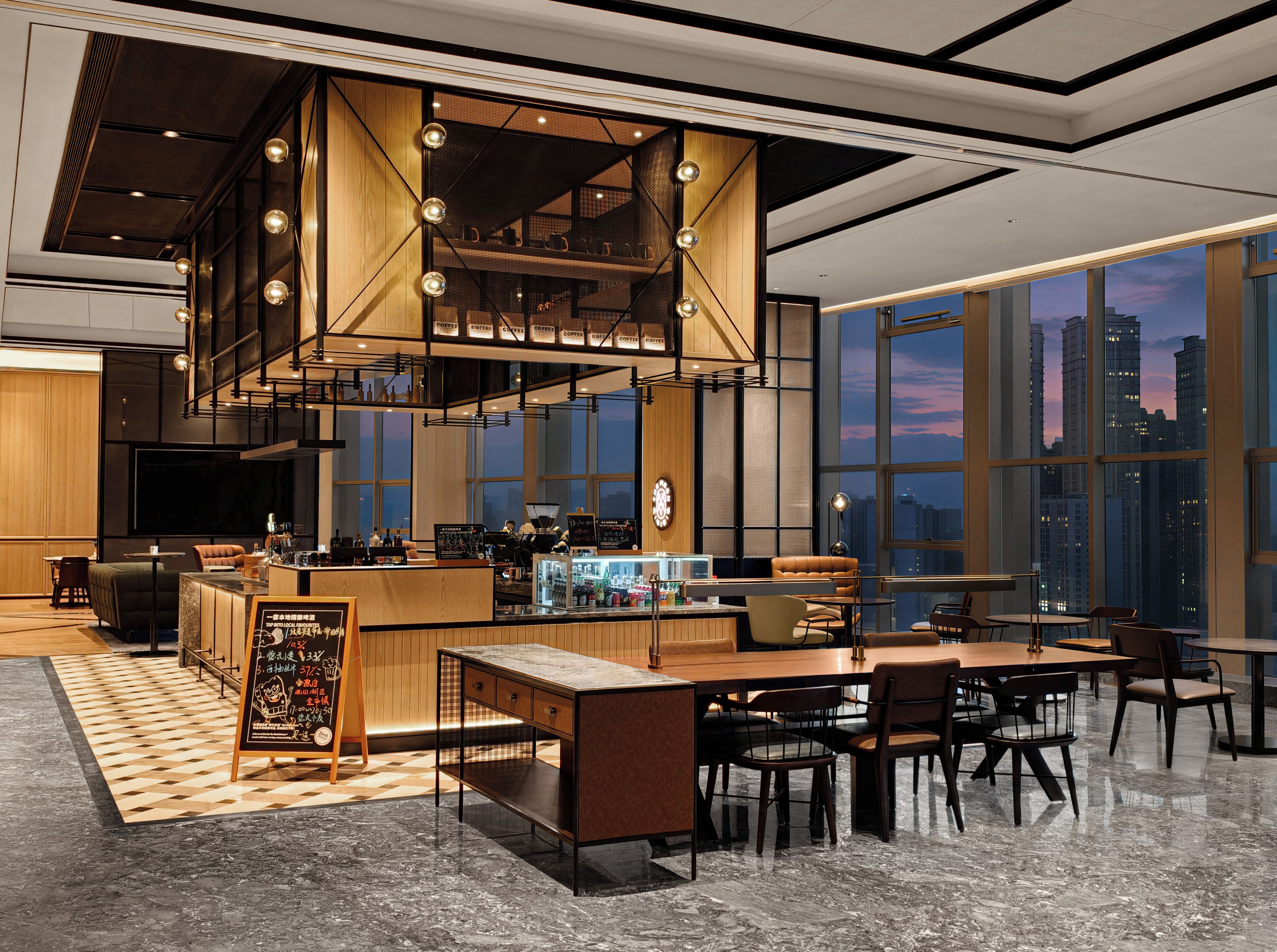 A modern interior with a bar area, seating, and large windows offering city views.