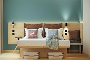 A bed with two pillows, a bedside lamp, and a headboard with wall-mounted lights. - Moxy St. Julian's Malta (St. Julian's)