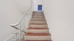Eine Treppe mit Metallgeländern führt zu einer Tür mit einem Fenster darüber.