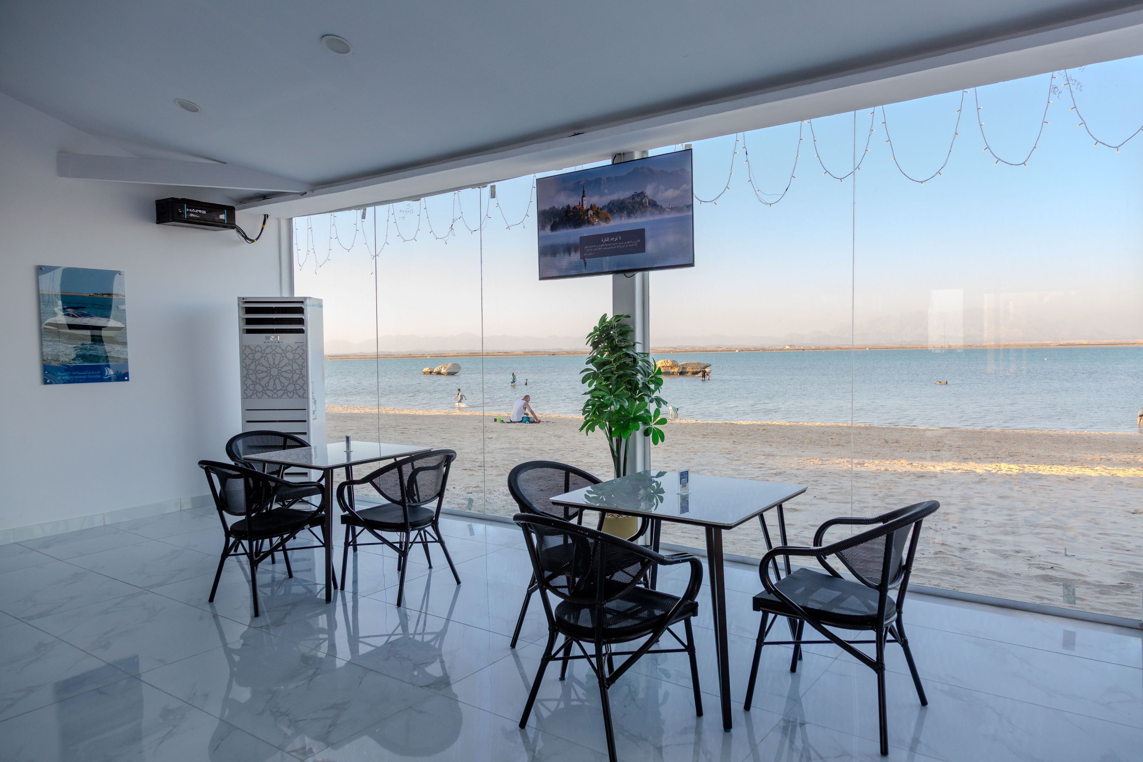 A modern indoor seating area with a view of the beach.
