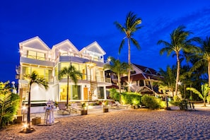 A beachfront property with multiple levels, outdoor seating, and palm trees. - B1 Beachfront (Koh Samui)