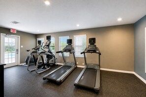 A fitness room with treadmills, stationary bikes, and a pool view. - The Olive Loft  - Near AT&T Stadium, Six Flags, DFW Airport Globe Life, (Grand Prairie)