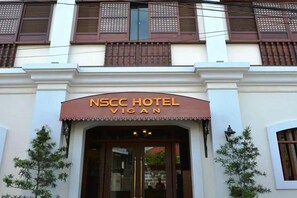 The NSCC Hotel Vigan facade with a prominent entrance and traditional architectural elements. - Nscc Hotel Vigan by Zuzu (Vigan)