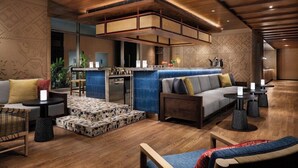 A modern interior with a wooden ceiling, a bar area, seating arrangements, and a patterned floor. - Taj Puri Resort and Spa, Odisha (Brahmagiri)